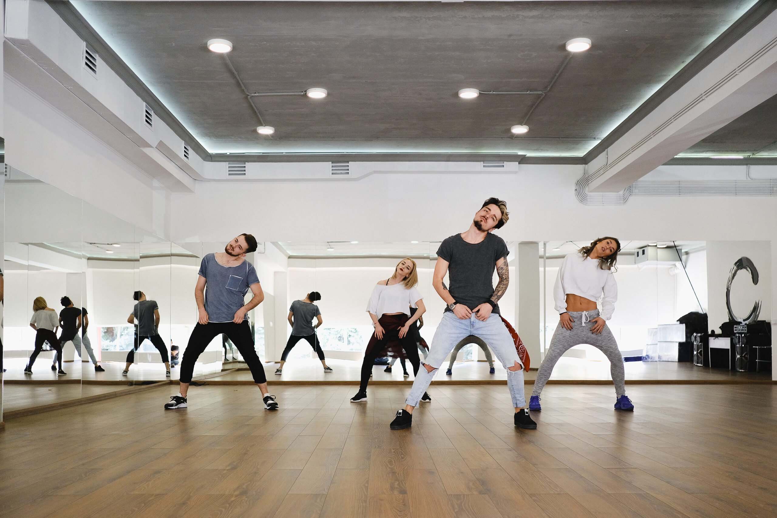 Group of young modern dancers dancing in the studio. Sport, dancing and urban culture concept